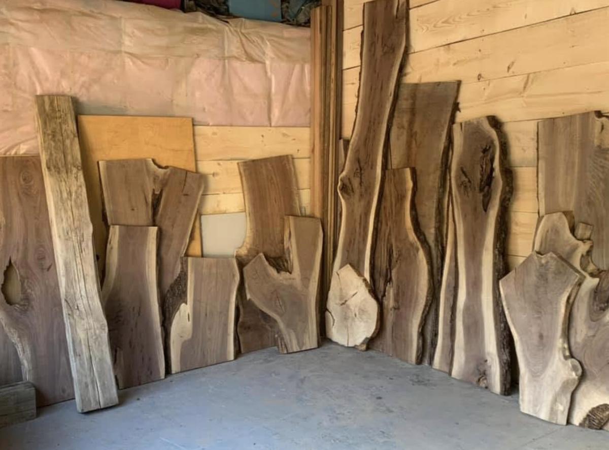 Live edge slabs leaning against a wall